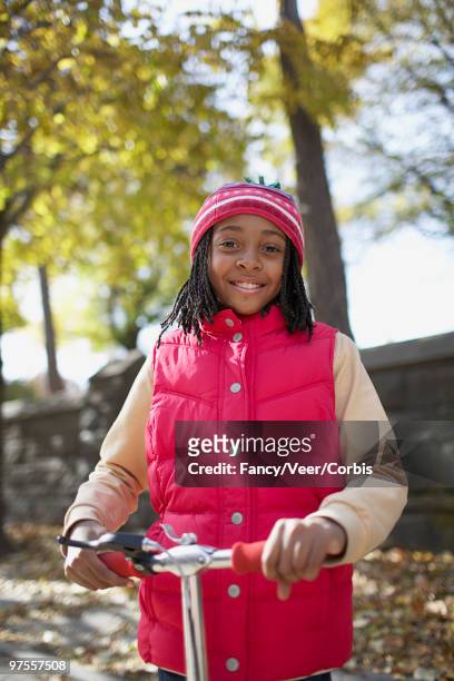 girl riding scooter - children only braided ponytail stock pictures, royalty-free photos & images