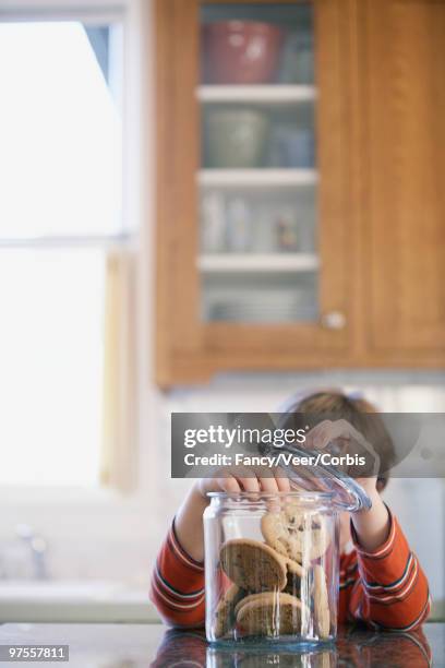 boy taking chocolate chip cookies - male hair removal stockfoto's en -beelden