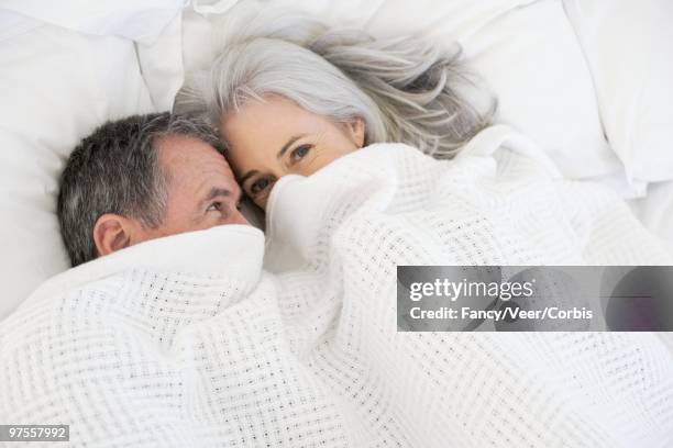 couple in bed - couple portrait soft stock pictures, royalty-free photos & images