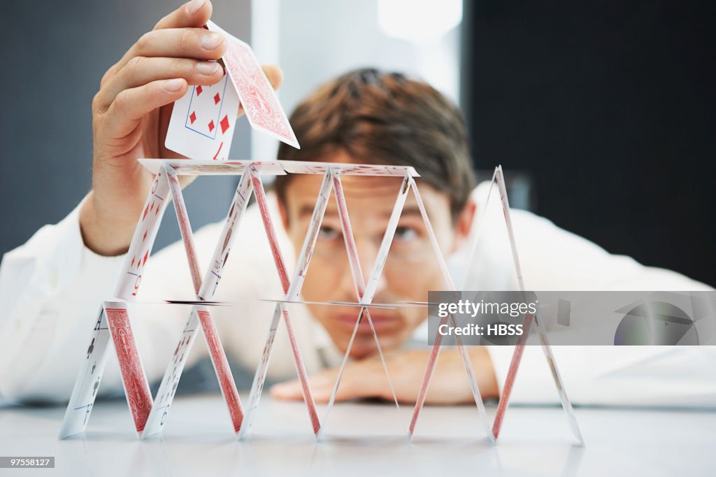 Businessman building a house of cards