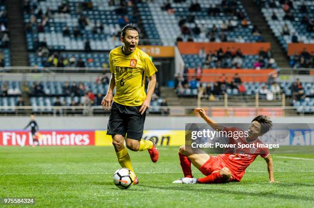 Guangzhou Defender Feng Xiaoting plays against Jeju FC Forward Ryu Seung-Woo during the AFC Champions League 2018 Group Stage G Match Day 4 between...