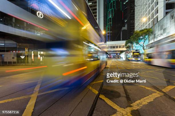 a bus rushing through the central intersection in the heart of hong kong - didier marti stock pictures, royalty-free photos & images