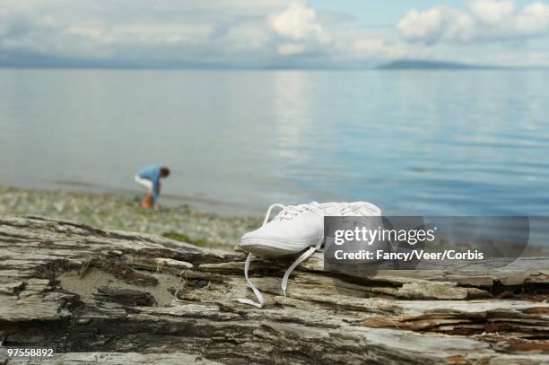 woman on a beach - lace fastener stock-fotos und bilder