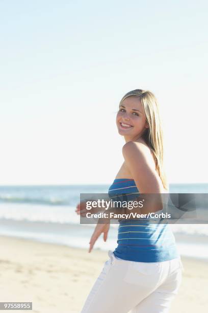 happy woman at the beach - long blonde hair in the wind stock pictures, royalty-free photos & images