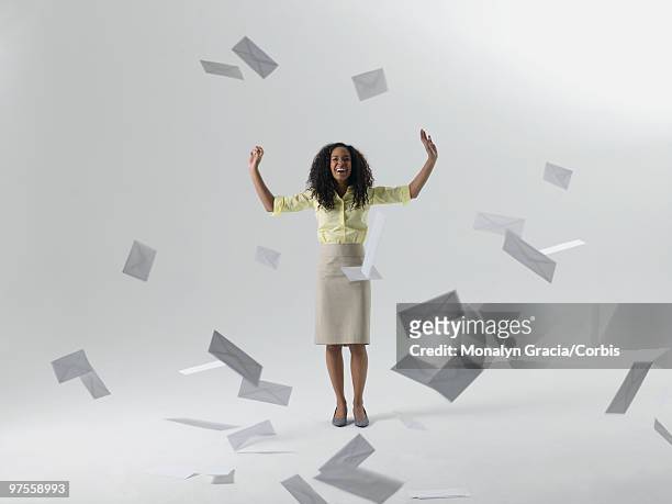 young businesswoman throwing envelopes - corbiscom stock pictures, royalty-free photos & images