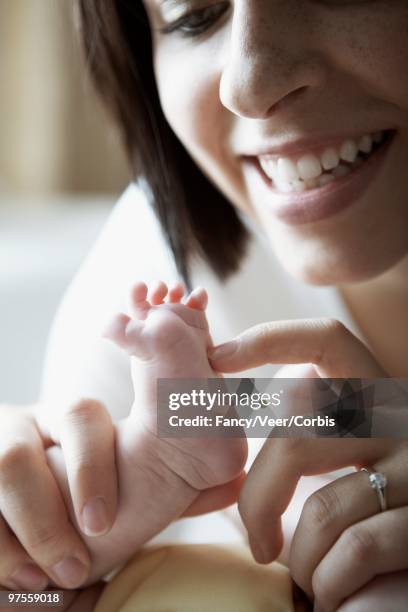 mother and baby - tickling feet stock pictures, royalty-free photos & images