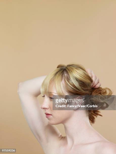 woman pulling hair back - woman pulling hair back stock pictures, royalty-free photos & images