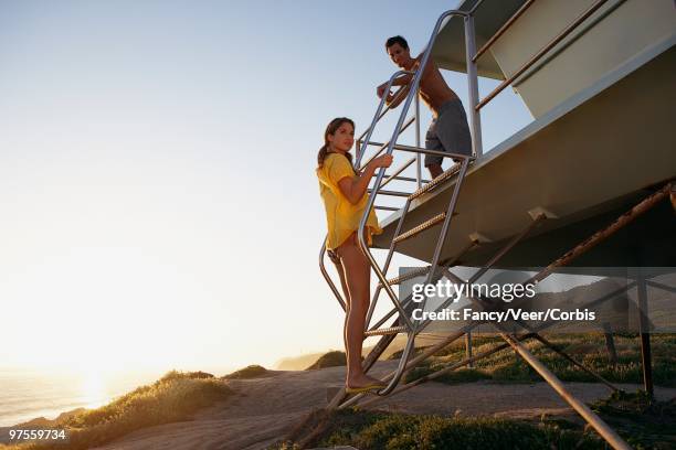 man and woman waiting - board shorts stock pictures, royalty-free photos & images