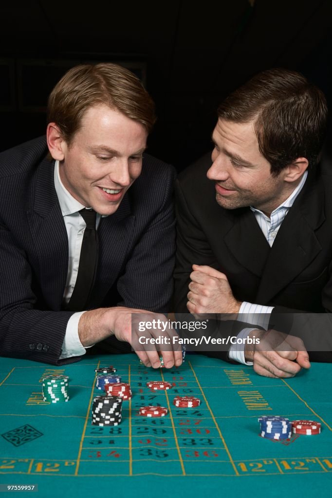 Friends placing bet on roulette game