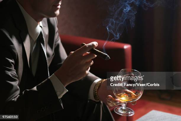 man with cigar and cocktail - the fan of cigars stock pictures, royalty-free photos & images