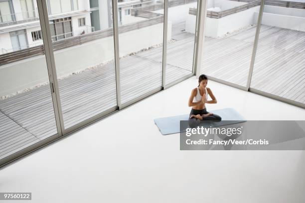 woman doing yoga - fashion woman floor cross legged stock pictures, royalty-free photos & images