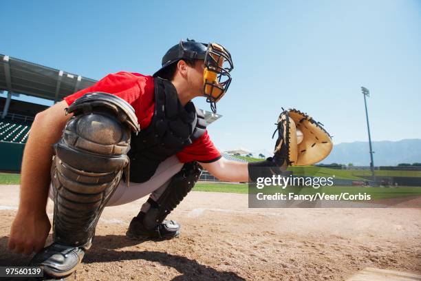 catcher holding baseball in mitt - baseball catcher imagens e fotografias de stock