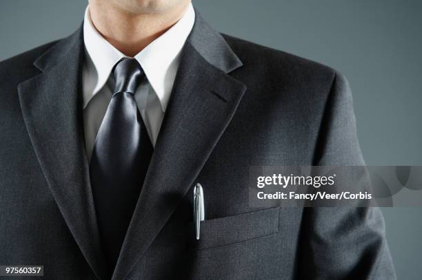 businessman with pen in pocket - solapa papel fotografías e imágenes de stock