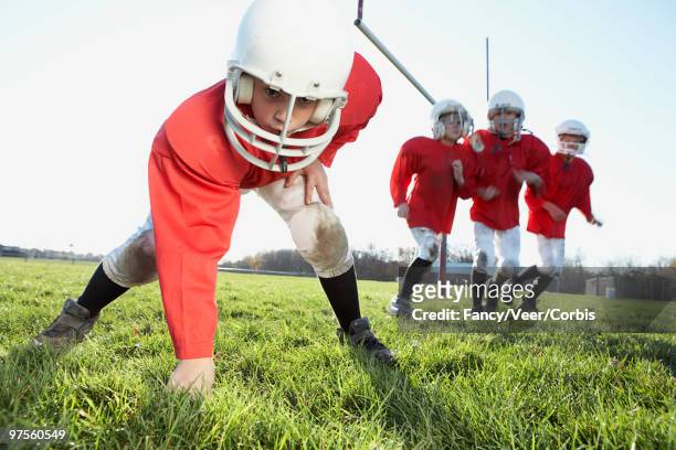 boys playing football - american football uniform stock pictures, royalty-free photos & images