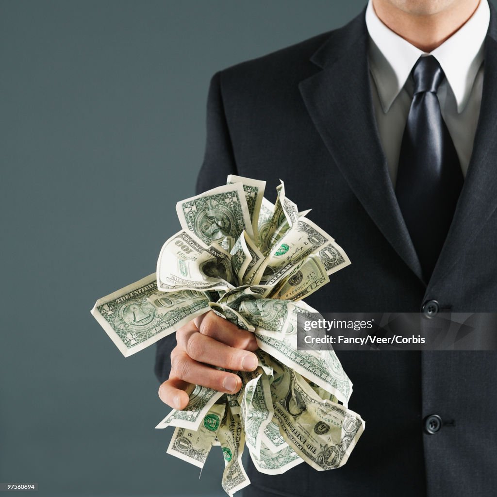 Businessman holding US currency