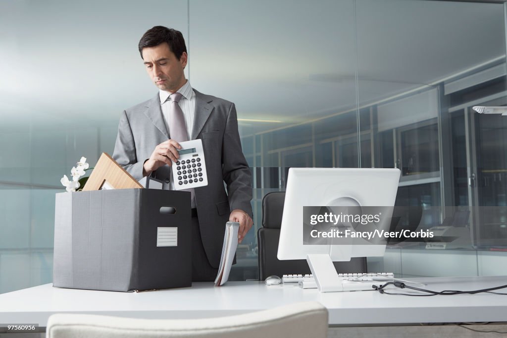 Businessman packing office belongings