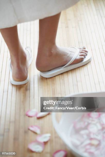 woman standing in flip flops next to footbath - robe rose stock pictures, royalty-free photos & images