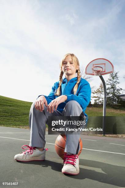 girl sitting on basketball - children only braided ponytail stock pictures, royalty-free photos & images