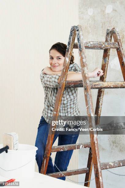 woman leaning on ladder - girl next door stock pictures, royalty-free photos & images