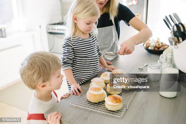 nordic family making semla buns in the kitchen - flour sifter stock pictures, royalty-free photos & images