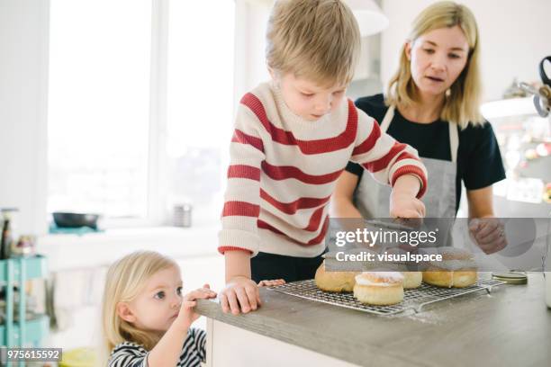 nordic family making semla buns on shrove tuesday - flour sifter stock pictures, royalty-free photos & images