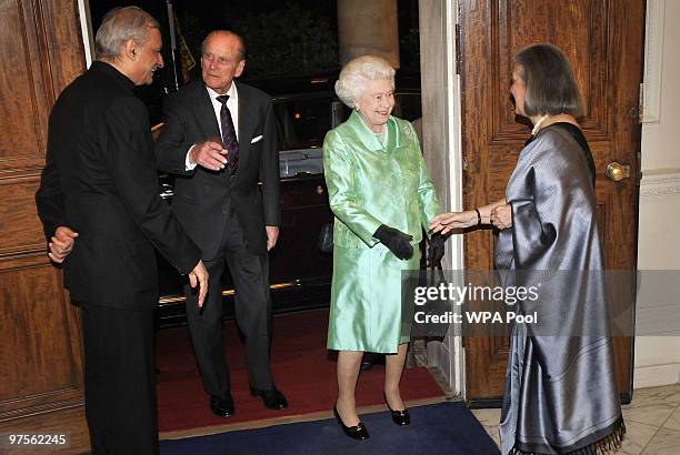 Queen Elizabeth II and Prince Philip, Duke of Edinburgh are greeted by Commonwealth Secretary General Kamalesh Sharma and his wife as they arrive at...