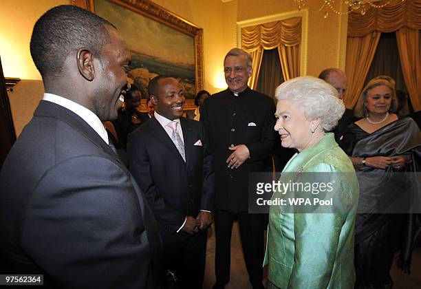 Queen Elizabeth II and Commonwealth Secretary General Kamalesh Sharma meet footballer Dwight Yorke and cricketer Brian Lara at the Commonwealth Day...