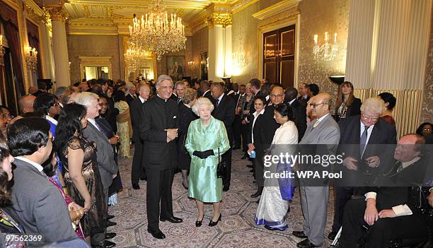 Queen Elizabeth II and Commonwealth Secretary General Kamalesh Sharma meet guests at the Commonwealth Day Reception at Marlborough House on March 08,...