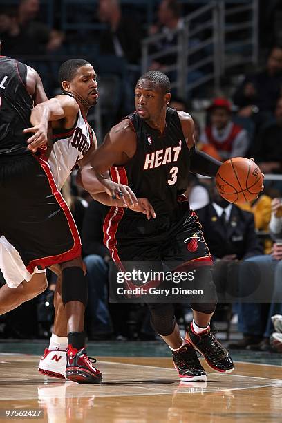 Dwyane Wade of the Miami Heat drives past Charlie Bell of the Milwaukee Bucks during the game on January 30, 2010 at the Bradley Center in Milwaukee,...