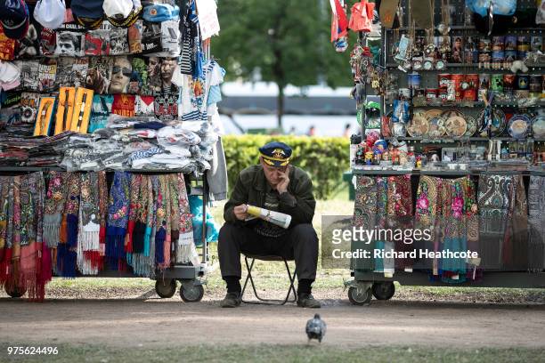 Souvenir seller waits for customers in St Petersburg ahead of the FIFA World Cup 2018 on June 13, 2018 in St Petersburg, Russia.