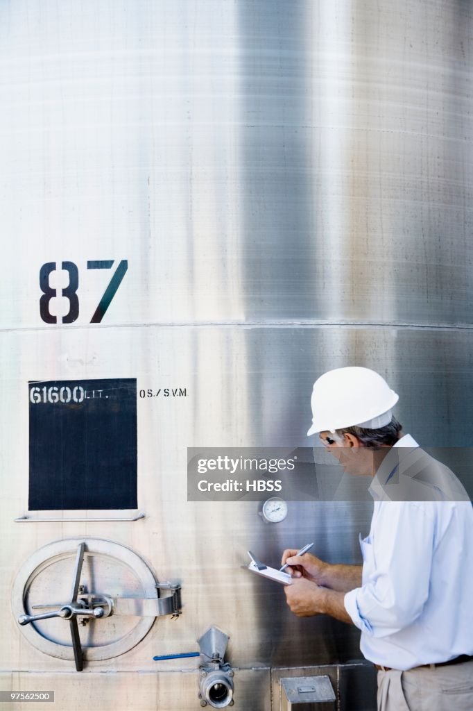 Industrial worker checking gauge