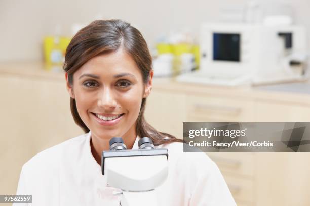 doctor using microscope - human hair microscope stock pictures, royalty-free photos & images