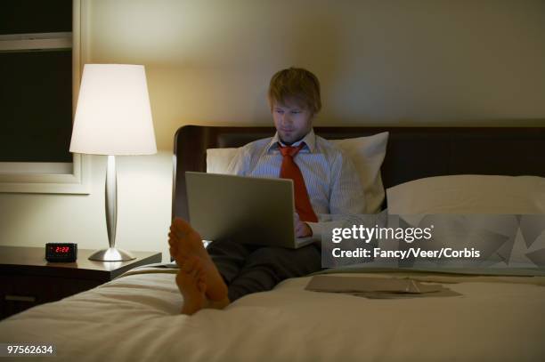 businessman using a laptop in a hotel room - jet lag ストックフォトと画像