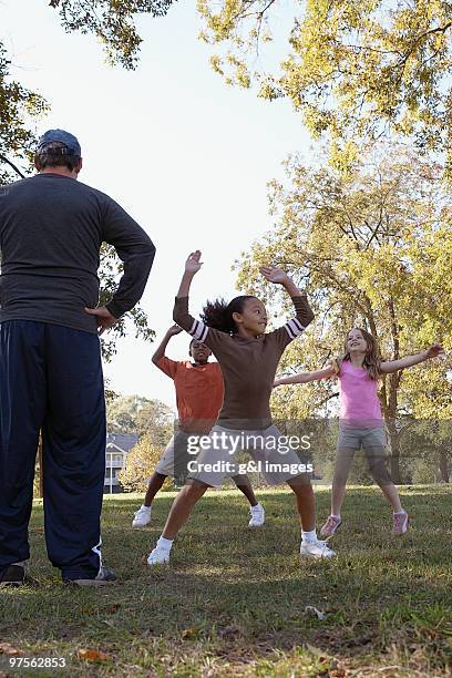 group of kids doing jumping jacks - jumping jack stock pictures, royalty-free photos & images