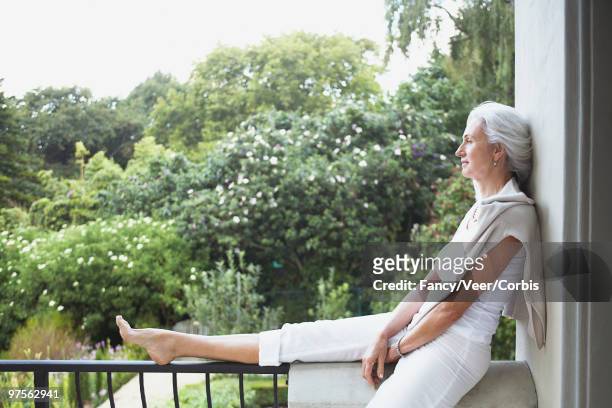 woman relaxing and enjoying nature - moment of silence stock-fotos und bilder