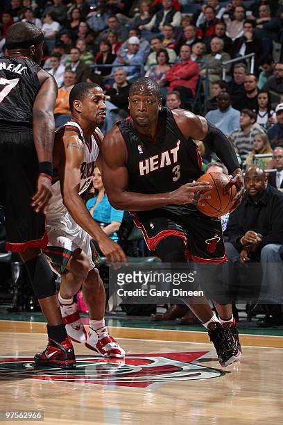 Dwyane Wade of the Miami Heat drives past Charlie Bell of the Milwaukee Bucks during the game on January 30, 2010 at the Bradley Center in Milwaukee,...
