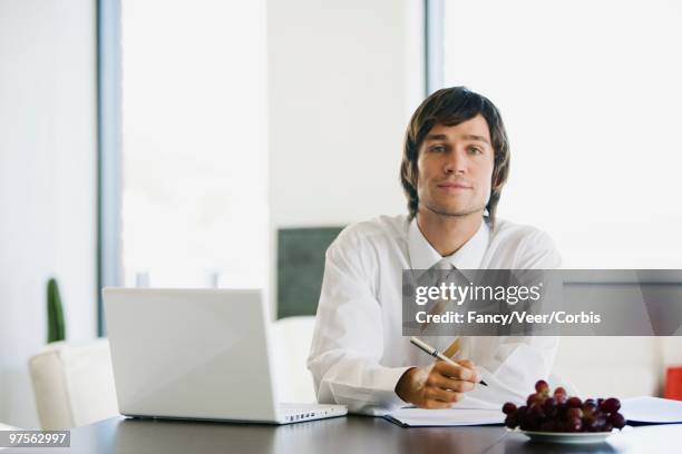 man working at home - young urban professional person stock-fotos und bilder
