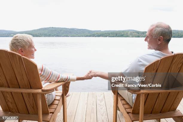 couple sitting by lake - nautical structure stock pictures, royalty-free photos & images