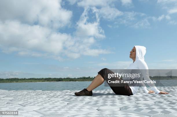 woman relaxing by a lake - nautical structure stock pictures, royalty-free photos & images