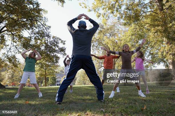 group of kids doing jumping jacks - jumping jack stock pictures, royalty-free photos & images