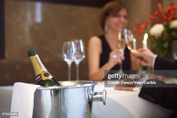 champagne bottle in ice bucket - luxury home dining table people lifestyle photography people stock pictures, royalty-free photos & images