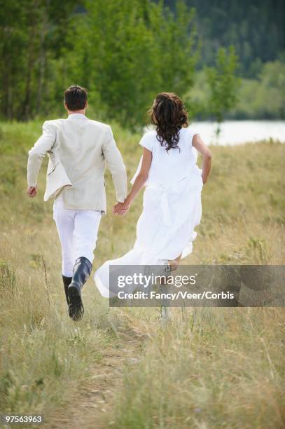 bride and groom running - white dress stock pictures, royalty-free photos & images