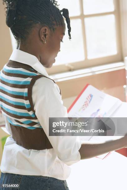 girl reading aloud in class - children only braided ponytail stock pictures, royalty-free photos & images