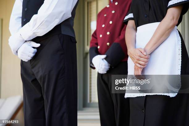 hotel staff waiting at attention - bellhop foto e immagini stock