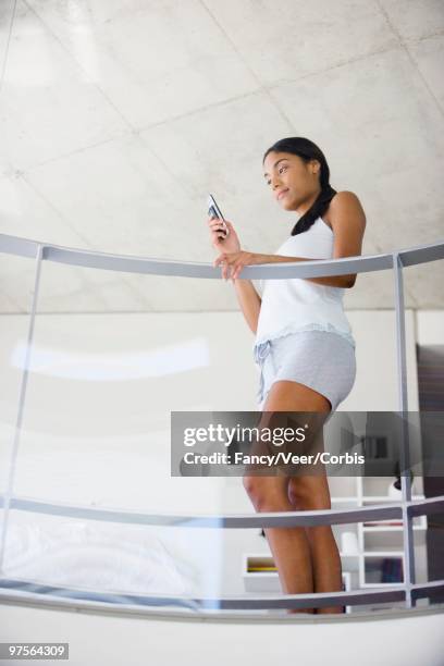 woman using a cell phone - young urban professional person stock-fotos und bilder