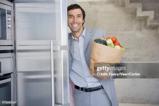 man with groceries - young urban professional person stock-fotos und bilder