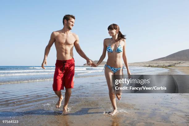 couple walking on a beach - girlfriend feet stock pictures, royalty-free photos & images