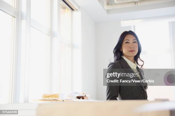 confident businesswoman - happy asian woman bright office stock-fotos und bilder