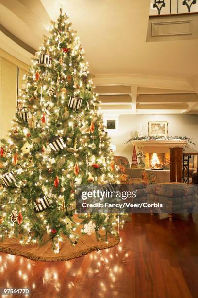 decorated christmas tree - optical flare stock pictures, royalty-free photos & images