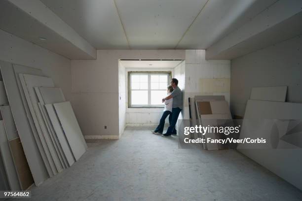 couple in new room - residential construction ahead of housing starts figures stock-fotos und bilder